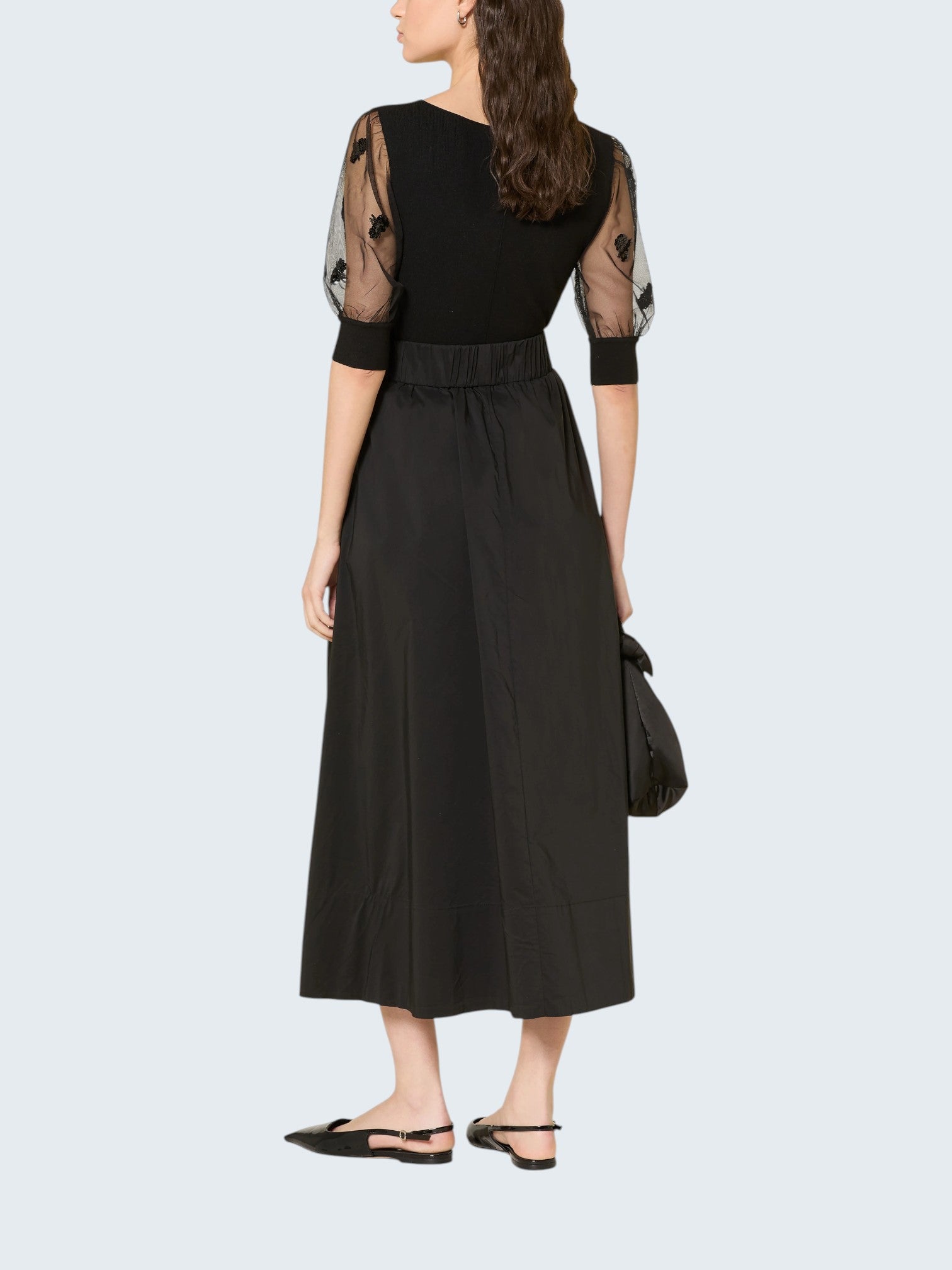 oui-ua.store black ribbed knit jumper with sheer mesh sleeves adorned with floral embroidery and sequins.