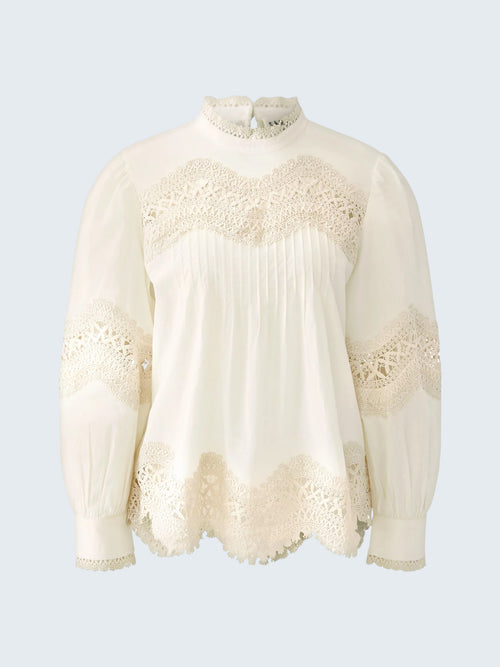oui-ua.store cream cotton blouse with lace trim, pintuck details, high neck, and button back. Voluminous sleeves.