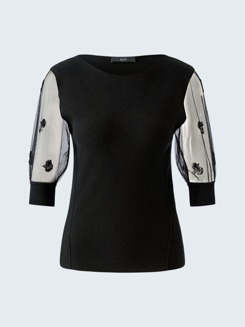 oui-ua.store black ribbed knit jumper with sheer mesh sleeves adorned with floral sequins. Round neck, short sleeves, and ribbed cuffs.