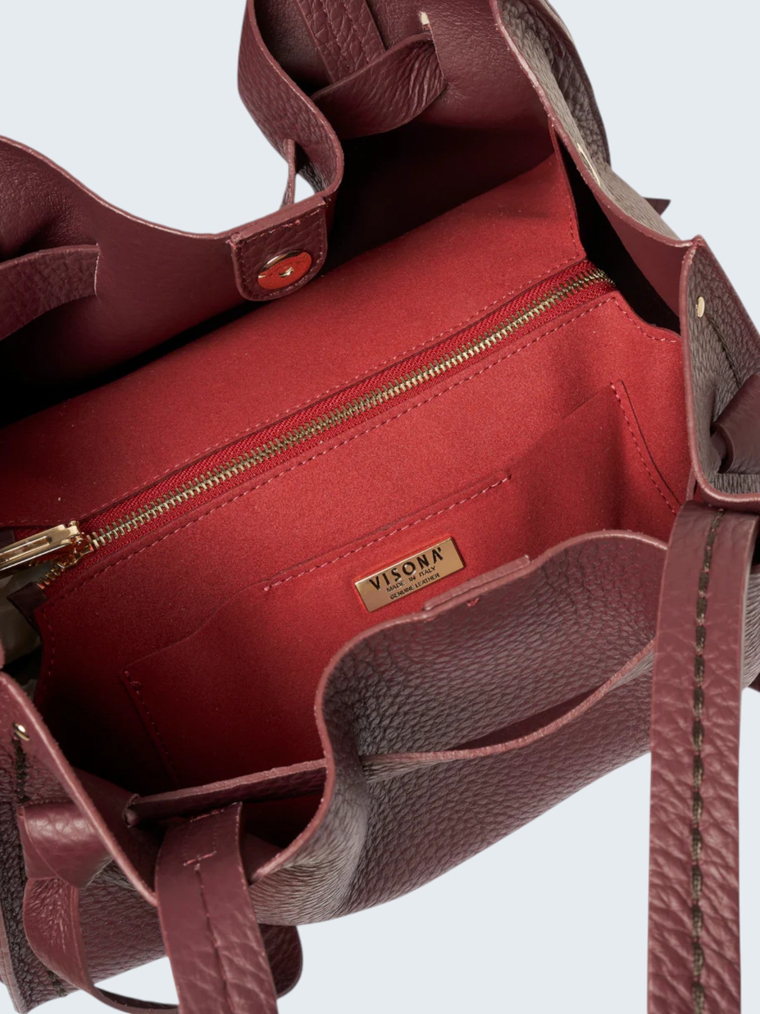 oui-ua.store burgundy pebbled leather tote bag with removable strap and interior zip pocket.